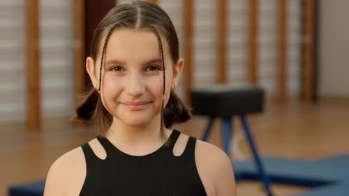 Close Up Happy Little Caucasian Girl Looking at Camera Smiling School Gym Sport Physical Education