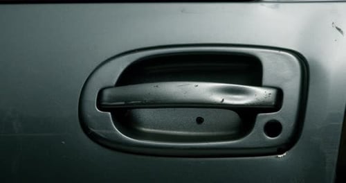 Bullet Impact on Car Door Handle with Splatter