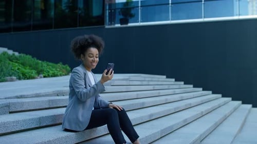 Young Woman on Video Call Sitting on Stairs