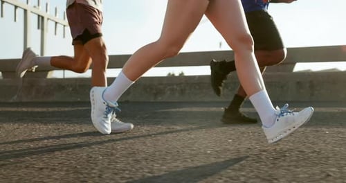 Fitness, legs and group with running on bridge for marathon training, cardio exercise