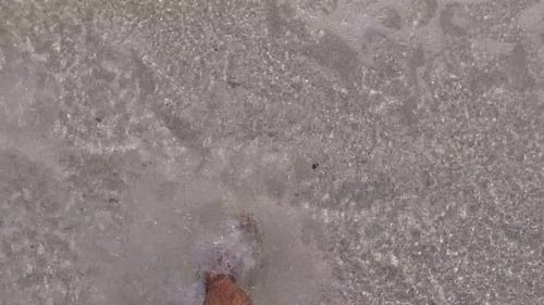 Barefoot Man Walks Through Clear Shallow Tropical Water