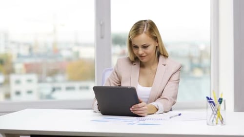 Woman Works with Tablet at Bright Desk