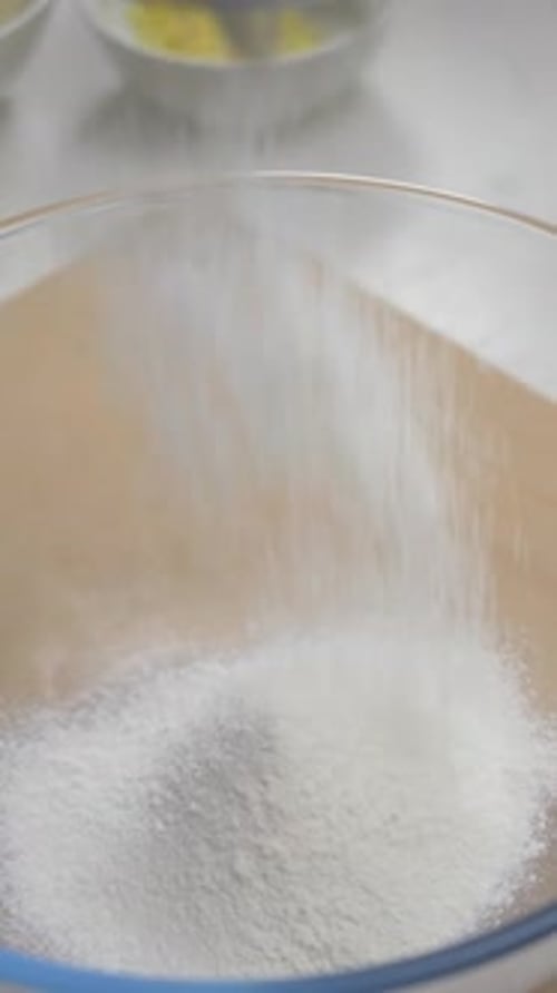 Female Cook Sifts Wheat Flour Through Metal Sieve