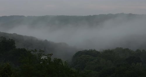 Fog over the forest in the mountains. Time lapse.