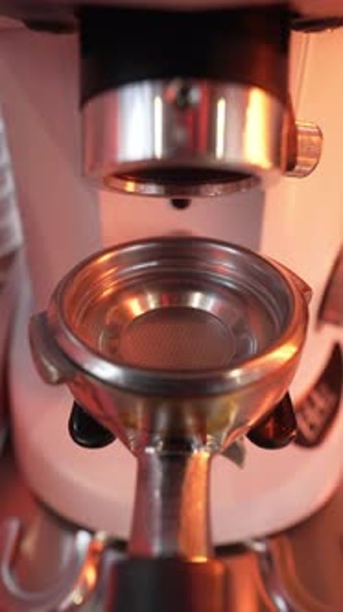 Coffee Grounds Dispensed into Portafilter from Coffee Grinder