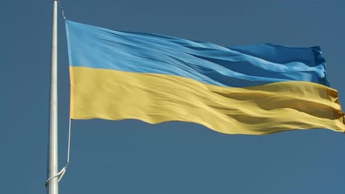 Ukraine Flag Waving Against a Blue Sky