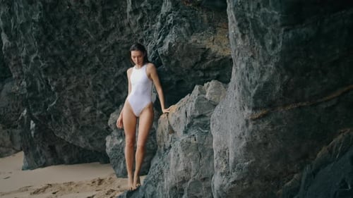 Elegant Beautiful Girl Standing at Stone Rock Posing on Camera Sensually. Attractive