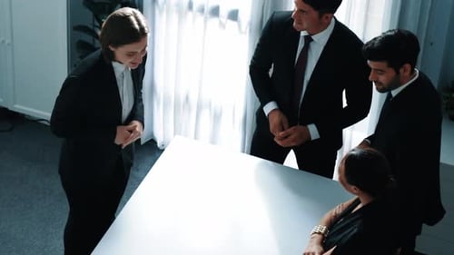 Business Team Gathers Around Conference Table for Meeting