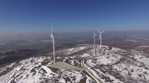 many wind turbines on top of a mountain