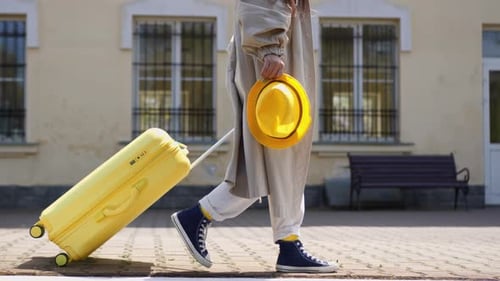Woman with Yellow Suitcase Walks to Train