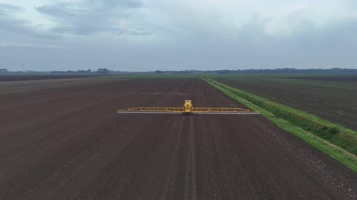 Tractor Spraying Pesticides On agricultural field With Sprayer