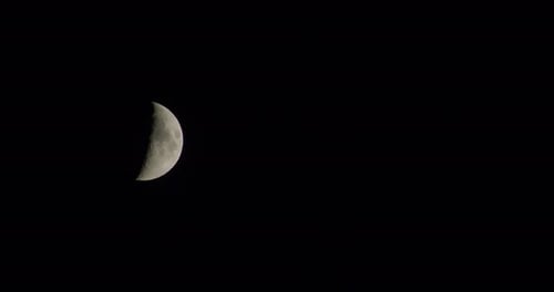 Waxing Crescent Moon Moving Across Night Sky