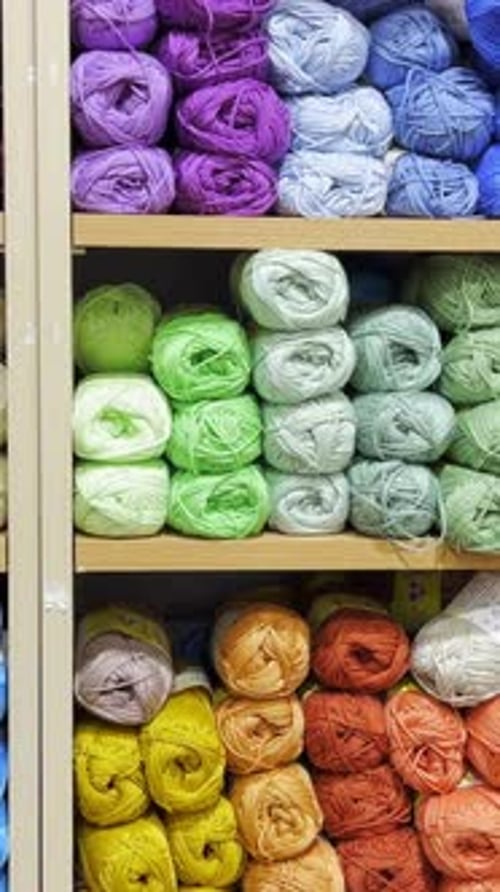 Woolen Threads of Different Colors in the Store on the Shelf Vertical Video