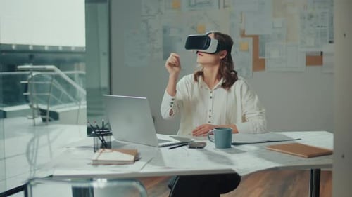 Woman Wearing VR Glasses Sits in a Bright Office Innovative Technologies