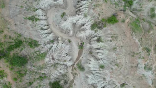 A drone glides over Tatacoa’s gray desert, revealing soft silver hills and quiet canyons. Gentle