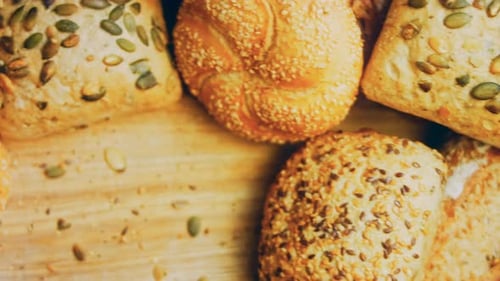 Appetizing Variety of Bread Rolls on Wooden Board