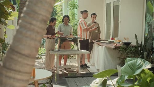 Group of People Cooking during Grill Party Outdoors