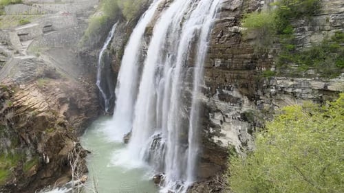 Majestic Waterfall Flowing Down Rocky Cliffside