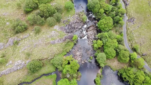 Direct view from above on the river and road flowing next to each other