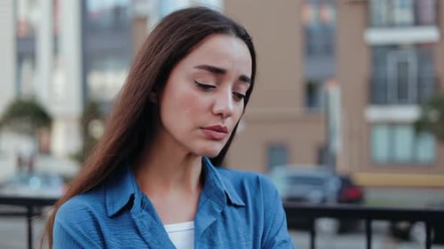 Thoughtful Young Woman in Urban Close-up