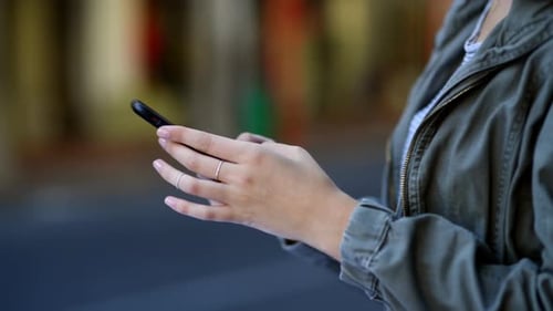 Woman, hands and phone in city for social media, communication or outdoor networking in road