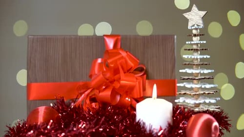 Christmas present and other decorations, turning from side to side in front of the camera
