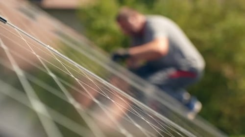 PV professional installing new eco Solar Panels on rooftop, static, day