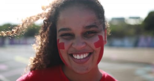 Red Sport Fan Smiling Out of the Stadium Before Football Match -