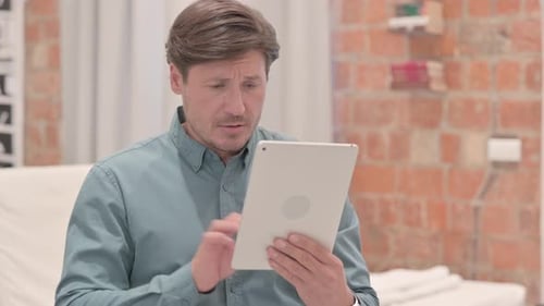 Man Using Tablet Indoors