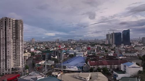 Vibrant Cityscape Under Cloudy Skies Aerial View