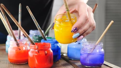 Painting Tools Brushes in Glass Jars Waiting for Work
