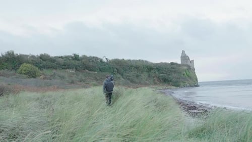 A Videographer walking to his outdoors location at the beach