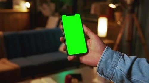 Hands Using Scrolling Mobile Phone with a Vertical Green Screen Social Media Smartphone Mock Up Dark