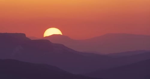 Sun close-up rising at mountain.