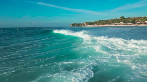 Aerial View of Balangan Beach Bali's Turquoise Waves and Sandy Shore with Lush Greenery Under a