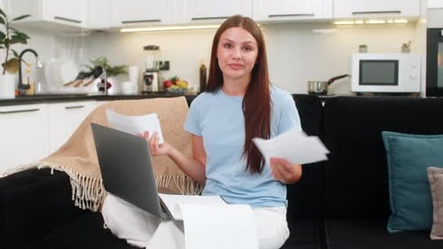 Young Woman with Laptop Struggles with Finance Paperwork High Utility Bills Surprised By Big Costs
