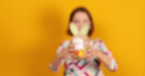 Smiling Girl Holding Easter Basket with Eggs
