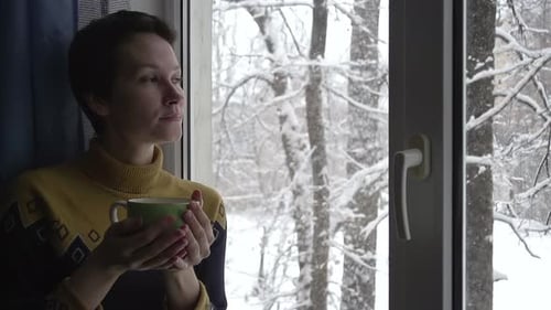 Woman Enjoying Cozy Winter Day with Hot Drink