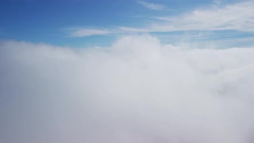The Camera Descends From the Thick Fog Above the Beautiful Ocean of Clouds Under the Clouds