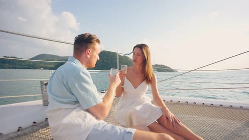 Couple Toasting on a Catamaran in Tropical Ocean