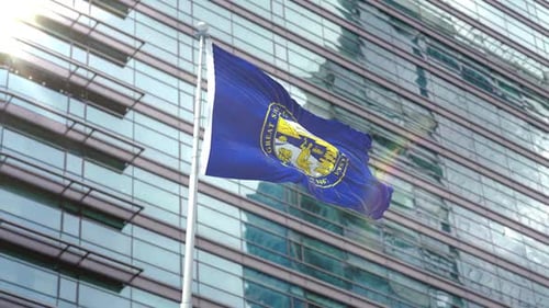 Nebraska State Flag Waving On Flagpole With Modern Building Background