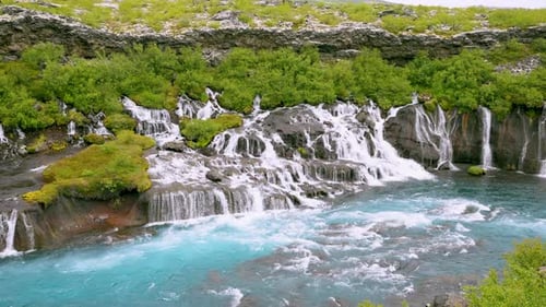 Slow Motion of Hraunfossar Waterfall and Turquoise River in West Iceland.