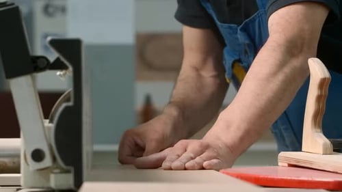 Man Working with Wood on Machinery