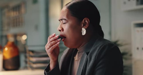 Woman Coughs in Office at Her Desk