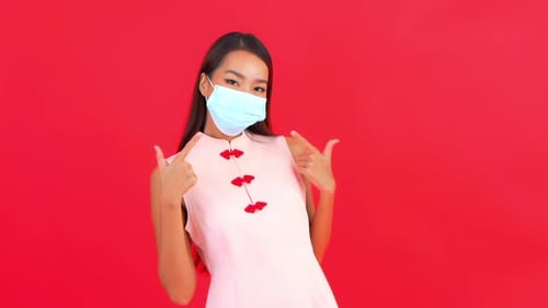 Woman in Face Mask Thumbs Up, Lunar New Year