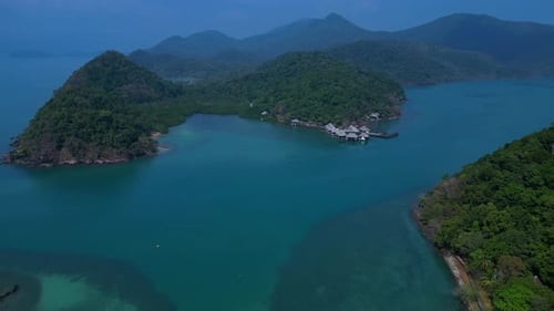 Island with pier leading to tropical beach. Marvelous aerial view flight drone