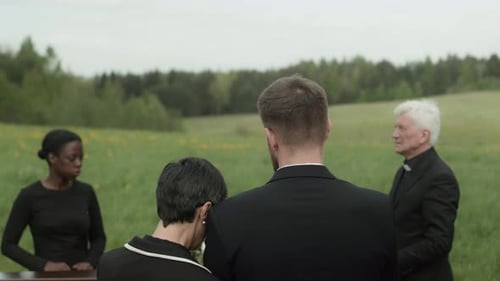 Mourners Gather for Outdoor Funeral Service