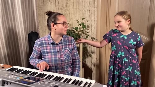 Woman and Girl at Piano in Home Interior