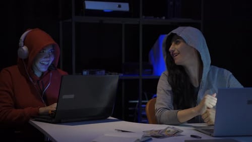 Hacker slyly laughing, doing cyber attack.