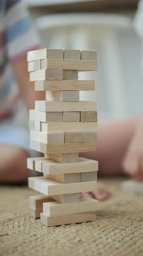 Children Playing Wooden Brick Tower Jenga Close Up
